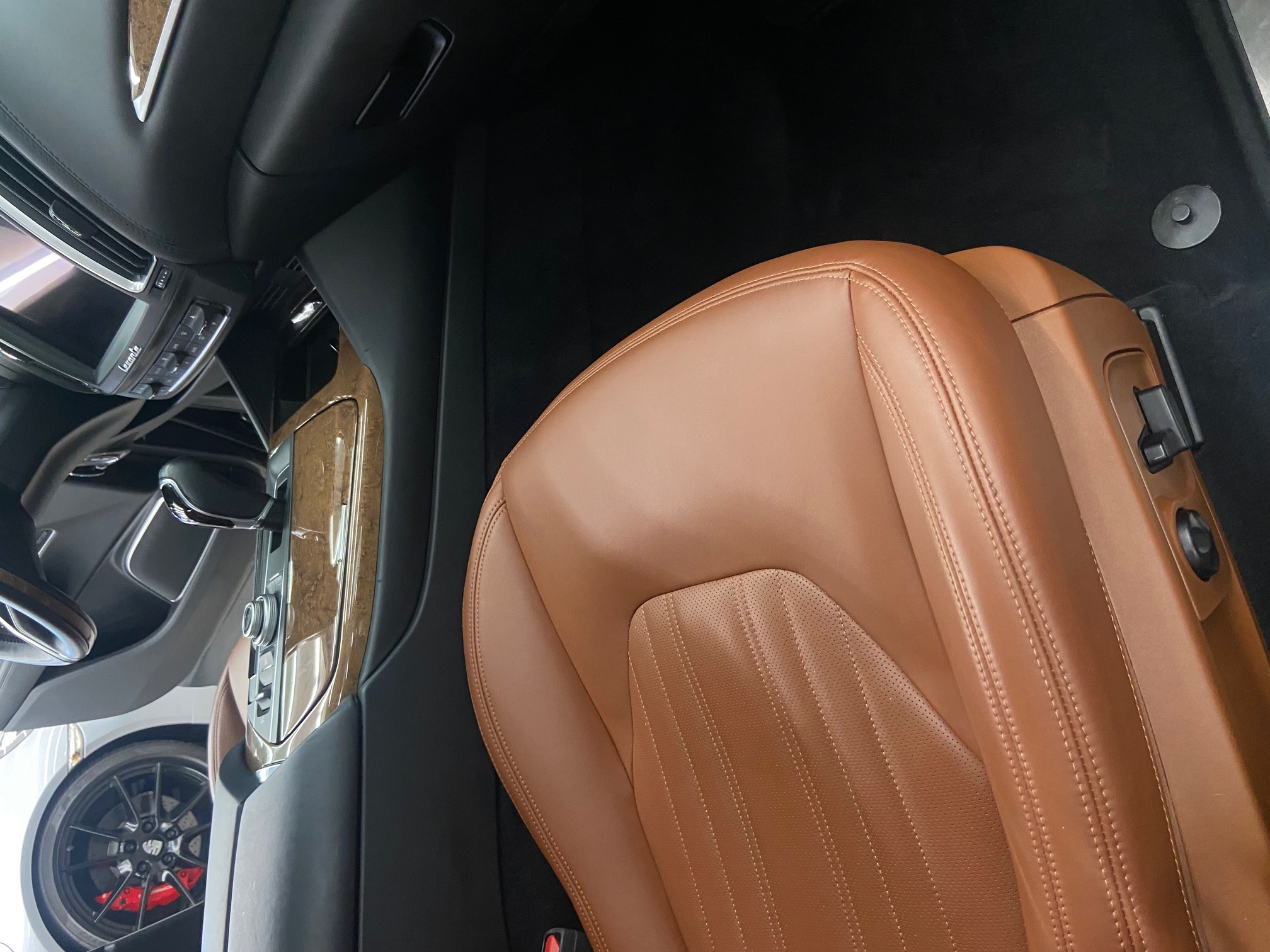 Detailed Maserati passenger interior with tan leather seats